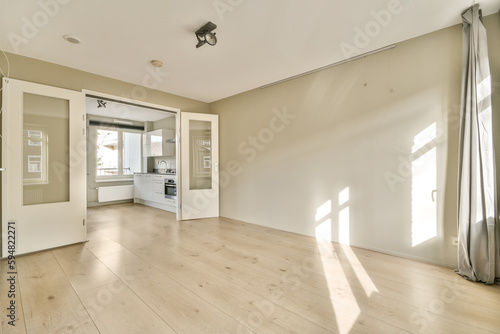 an empty living room with wood flooring and white walls in the room is very clean  but there is no light