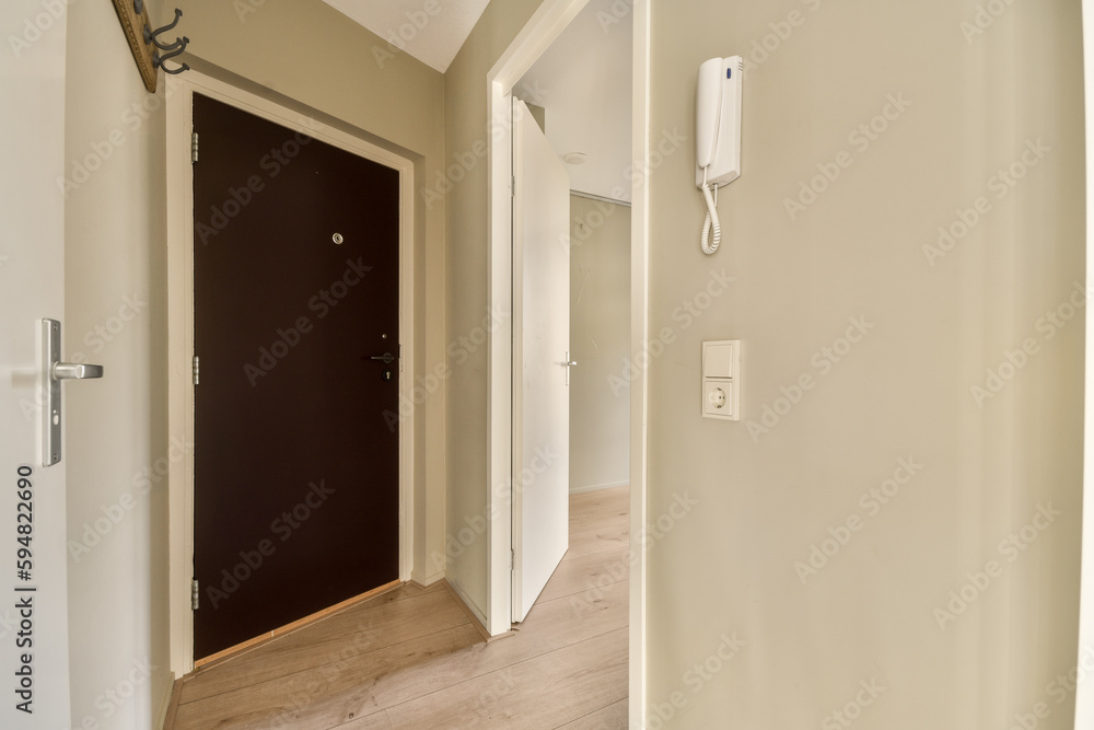 an empty room with white walls and wood flooring the door is open on the right side of the room an empty room with white walls and wood flooring the door is open on the right side of the room