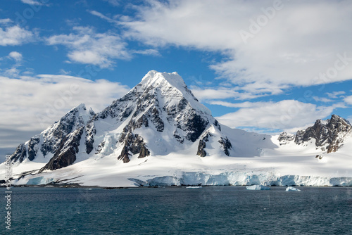 Dramatic Slouw Clad Mountains Rising Above the Sea and Glaciers on Antarctic Peninsula 