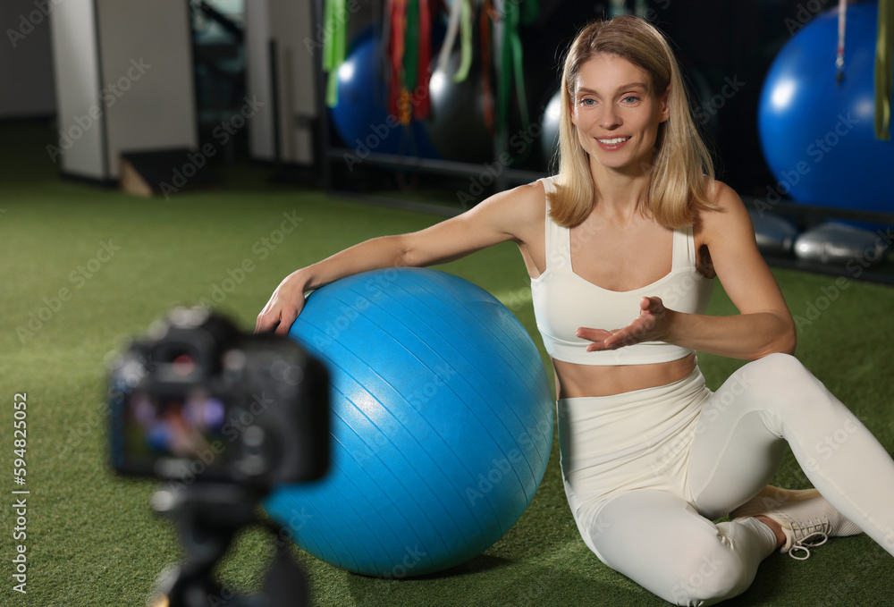 Fitness trainer recording online classes in gym Fitness trainer recording online classes in gym