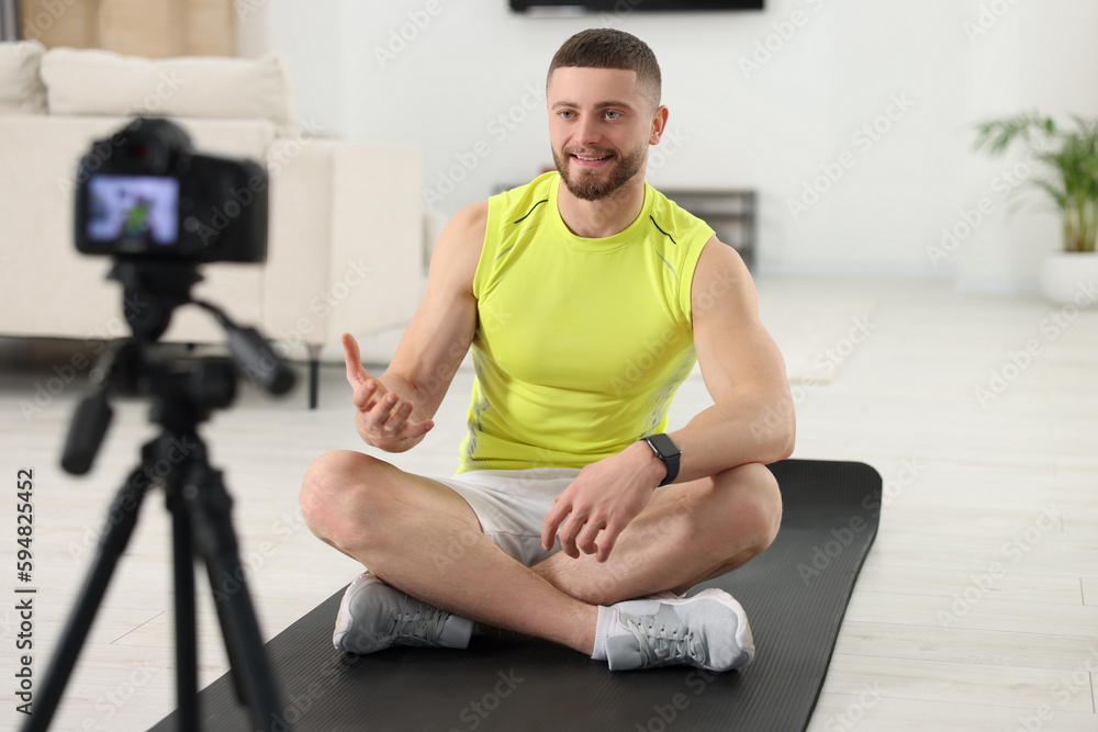 Trainer recording fitness lesson on camera at home Trainer recording fitness lesson on camera at home