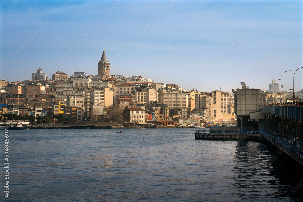 View of Beyoglu district with Galata Tower and Galata Bridge from the waters of the Golden Horn Bay on a sunny day, Istanbul, Turkey