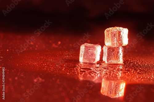 Red ice cubes on black background.