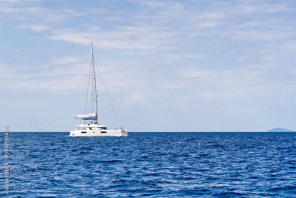 Yacht catamaran on the sea. Catamaran sailing on turquoise waters. Holiday or vacation at sea. Luxury yachts. summer