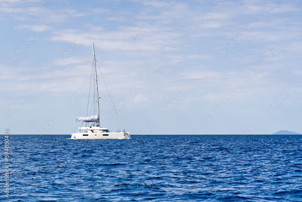 Yacht catamaran on the sea. Catamaran sailing on turquoise waters. Holiday or vacation at sea. Luxury yachts. summer Yacht catamaran on the sea. Catamaran sailing on turquoise waters. Holiday or vacation at sea. Luxury yachts. summer