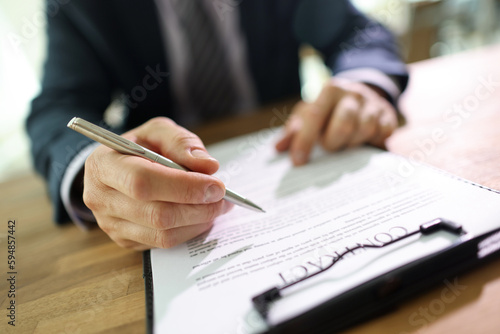 Slika na platnu Businessman in suit reads terms and conditions of contract