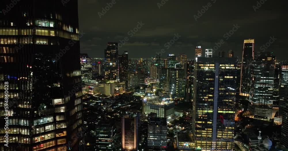 Aerial view of Jakarta with skyscrapers and the illumination of the night. Aerial view of Jakarta with skyscrapers and the illumination of the night.