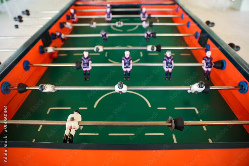 Fototapeta premium A foosball table is a recreational game symbolizing entertainment, skill, and socializing. It represents teamwork, competition, and the joy of play, and is often associated with bar and culture