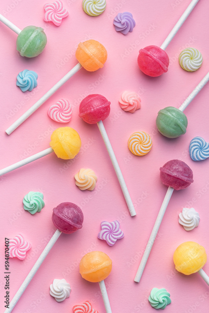 Sweet lollipops and candies on pink background Sweet lollipops and candies on pink background