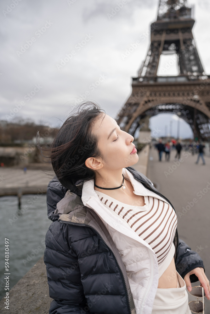 Woman near the Eiffel tower on a winter day.