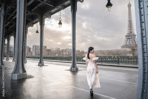 woman portrait under Bir Hakeim bridge with Eiffel tower. Paris, France.