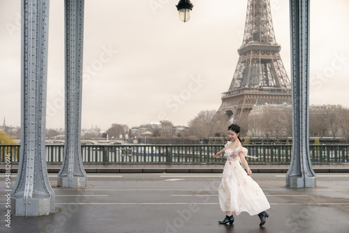 woman portrait under Bir Hakeim bridge with Eiffel tower. Paris, France. photo