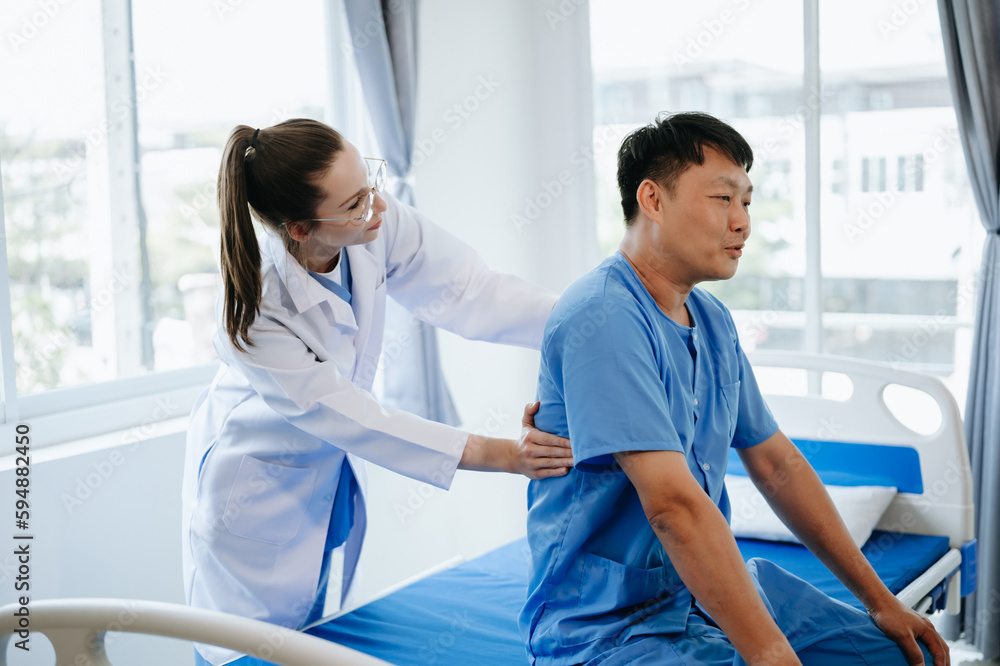 Fototapeta premium Doctor consulting with patient Back problems Physical on the bed in clinic therapy concept 