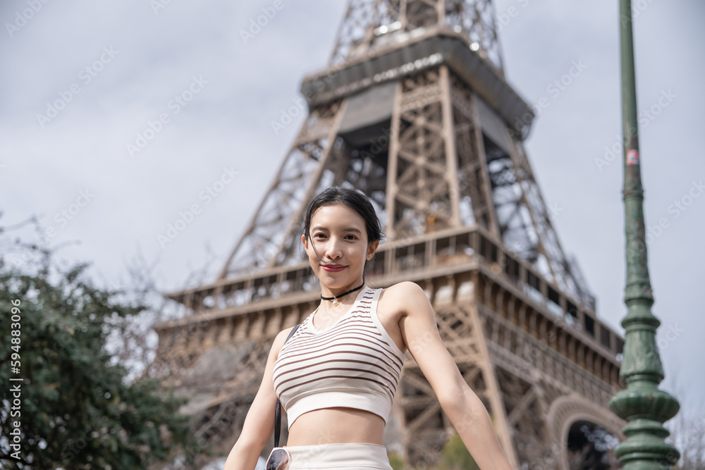 Woman near the Eiffel tower Paris, France.