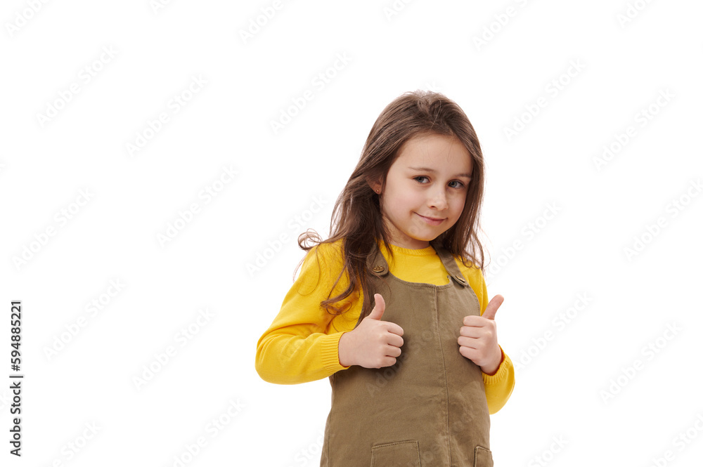 Isolated portrait on white background of an amazed happy excited Caucasian little child girl, showing thumbs up gesture, approval sign, expressing happiness and agreement. Excellent feedback. Isolated portrait on white background of an amazed happy excited Caucasian little child girl, showing thumbs up gesture, approval sign, expressing happiness and agreement. Excellent feedback.