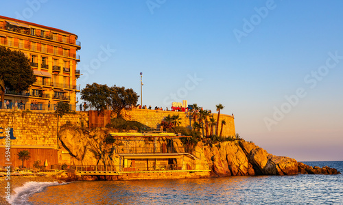 Sunset view of Colline du Chateau Castle Hill, Vieille Ville Castel Beach and Tour Bellanda Tower in Nice on French Riviera of Mediterranean Sea in France photo