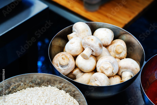 Mushrooms in a metal bowl. Preparing ingredients for cooking. Close up