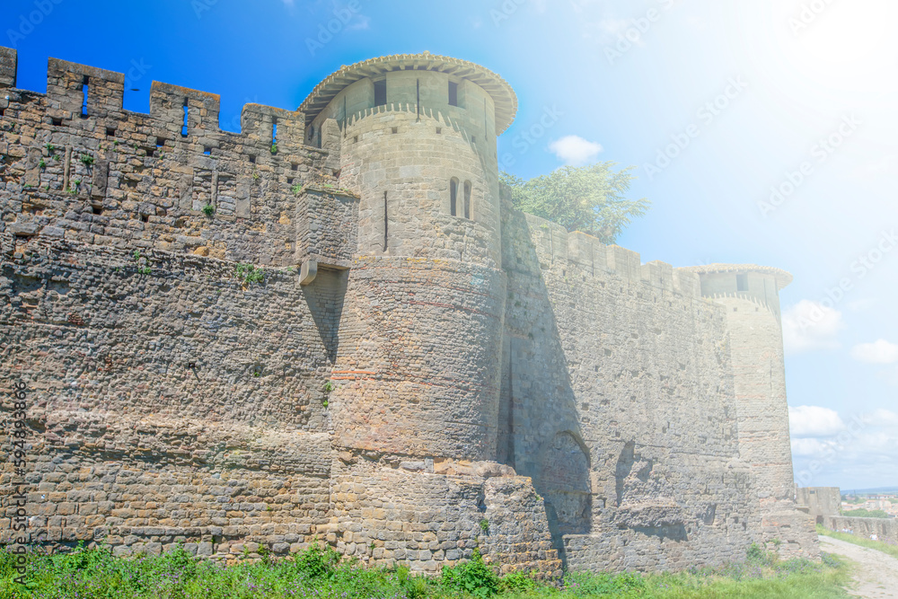 Ancient stone tower of the castle against the blue sky in soft sun light Ancient stone tower of the castle against the blue sky in soft sun light
