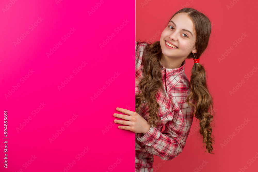glad girl behind blank pink paper with copy space for advertisement glad girl behind blank pink paper with copy space for advertisement