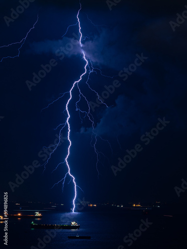 Lightning striking the sea at night.
