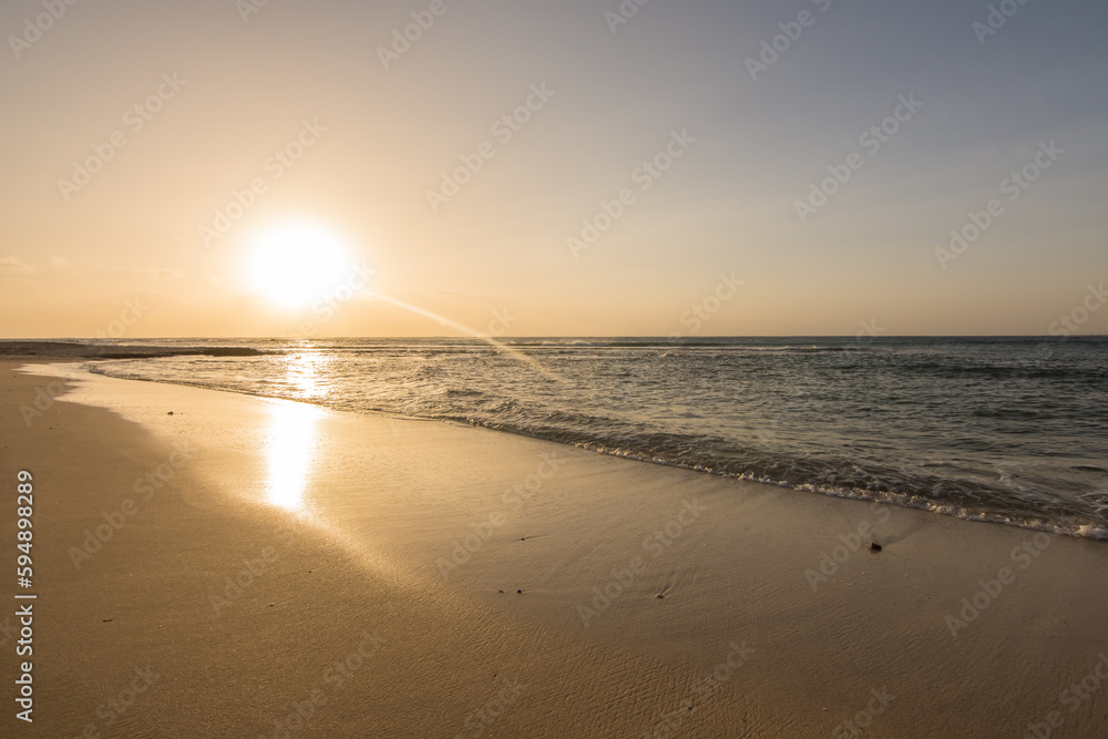 sunrise_at_the_wet_sandy_beach_with_waves_at_the_sea_in_egyp