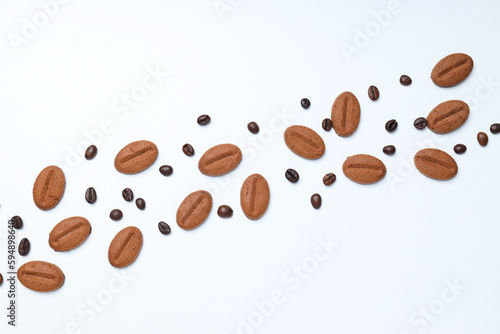 Concept of tasty snack for hot drink - cookies in the shape of coffee seeds