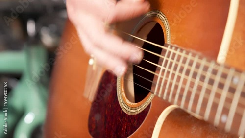 Close up of a man playing guitar.