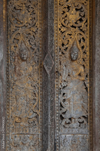 Patterns of angels carved from wooden on the church door of Wat Pa Ruak, which is an abandoned temple. Located at the way up Mount Phousi. AT Central Luang Prabang city in Northern of Laos.