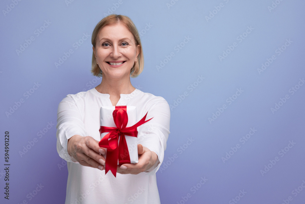 satisfied middle aged woman with gift box smiling satisfied middle aged woman with gift box smiling