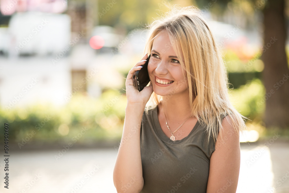 Beautiful woman walking in park and using phone Beautiful woman walking in park and using phone