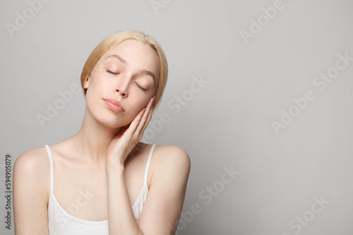 Perfect young woman with fresh healthy skin posing with closed eyes. Facial treatment  skincare and cosmetology concept