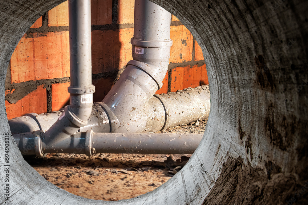 Sewer pipes in home basement. System of gray sanitary pipes when building a house. Sewer