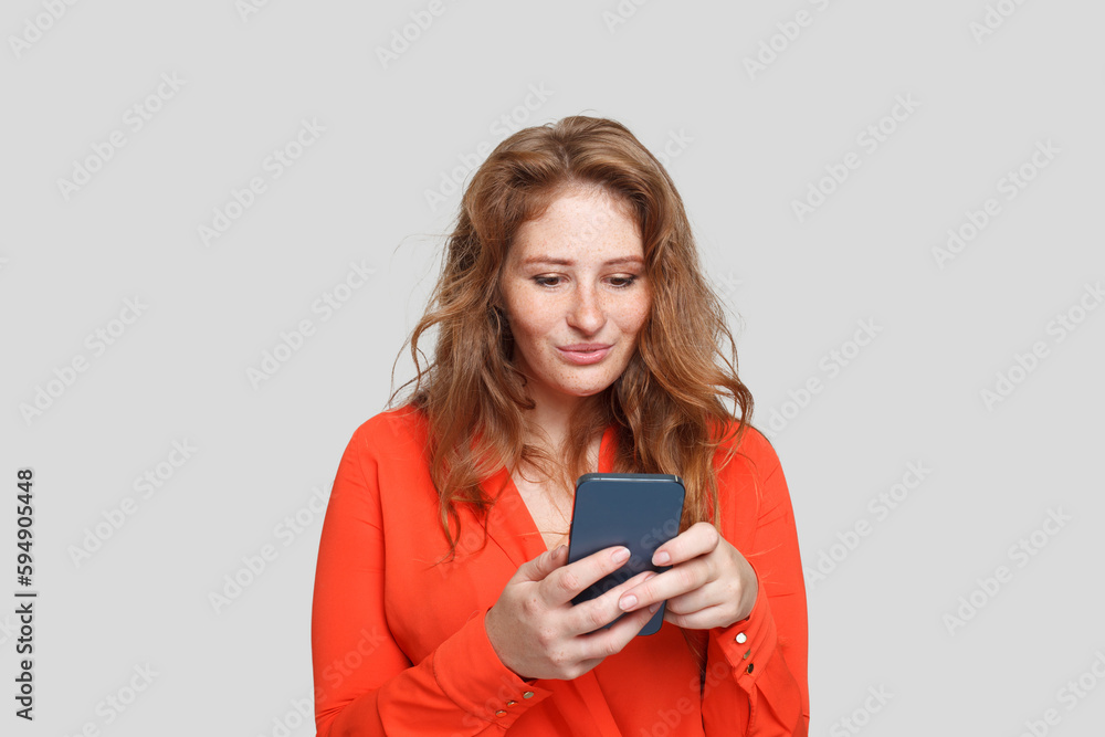 Cute woman with phone. Redhead female using smartphone Cute woman with phone. Redhead female using smartphone