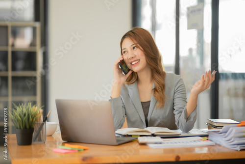 Asian businesswoman holding notebook about business, spending money