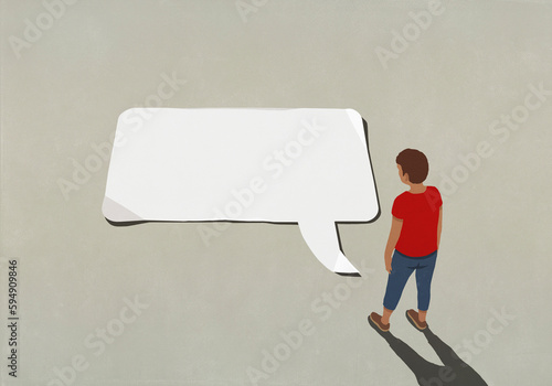Man looking down at large blank communication speech bubble
 photo