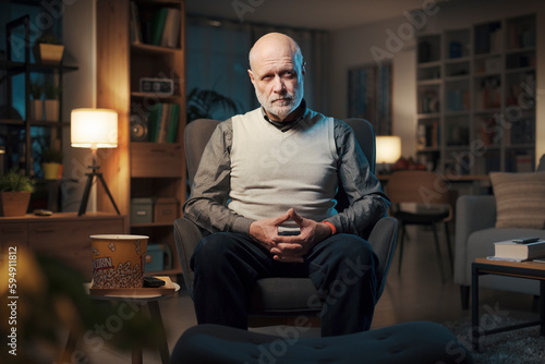 Senior man sitting in the living room © StockPhotoPro