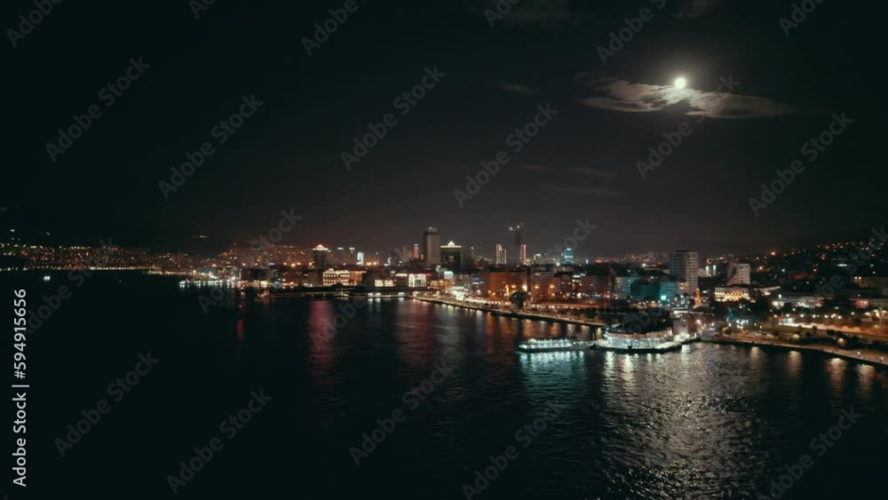 Aerial night shot over the sea with the ferryboats and city views in Konak Izmir Turkey. High quality 4k footage Aerial night shot over the sea with the ferryboats and city views in Konak Izmir Turkey. High quality 4k footage