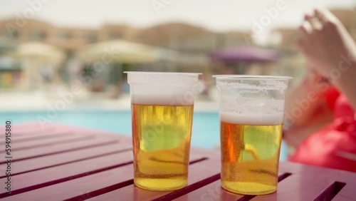 two glasses of light beer outdoors
