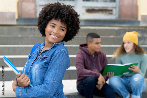 Young african american female student with group of hispanic young adults