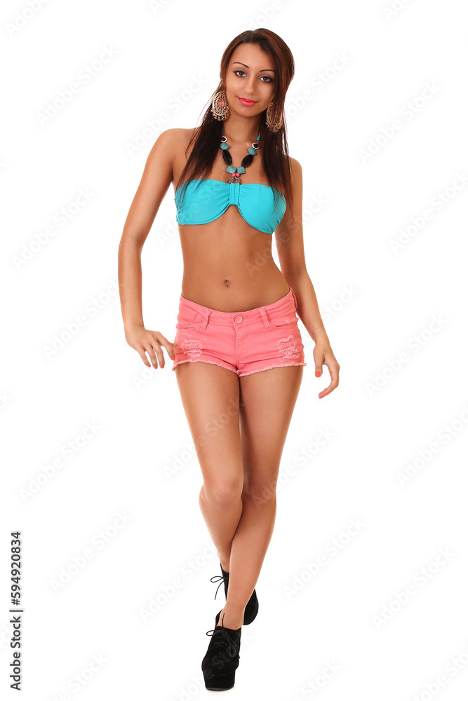 young woman in swimsuit and shorts on a white background young woman in swimsuit and shorts on a white background