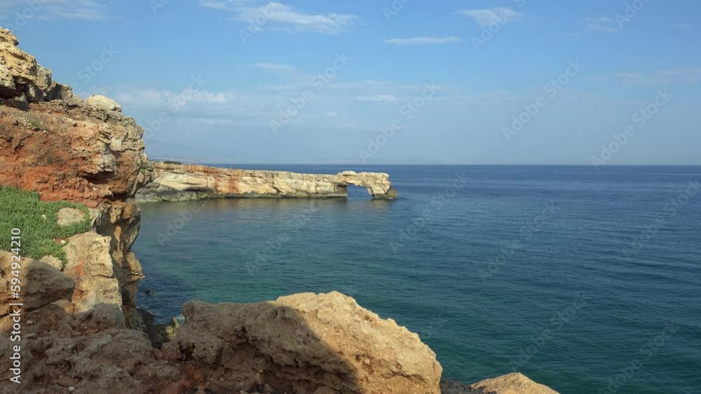 Video of stone arch Kamara and coastal rocks in the sea near Geropotamos beach on Crete, Greece. Video of stone arch Kamara and coastal rocks in the sea near Geropotamos beach on Crete, Greece.