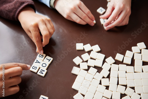Children playing scrabble at dining table