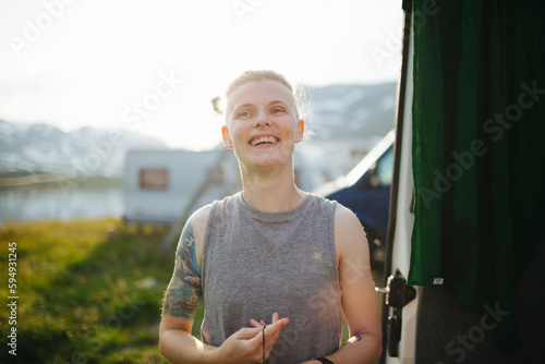 Smiling woman standing at camping site