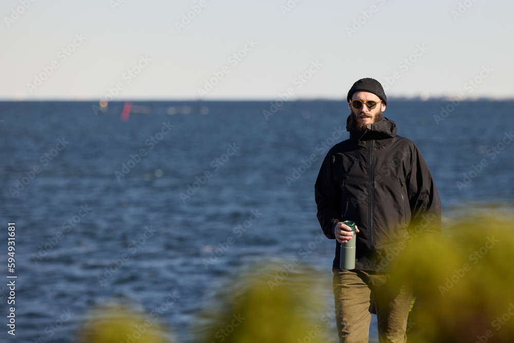 View of man standing at sea View of man standing at sea