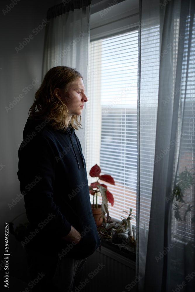 Sad man looking through window Sad man looking through window