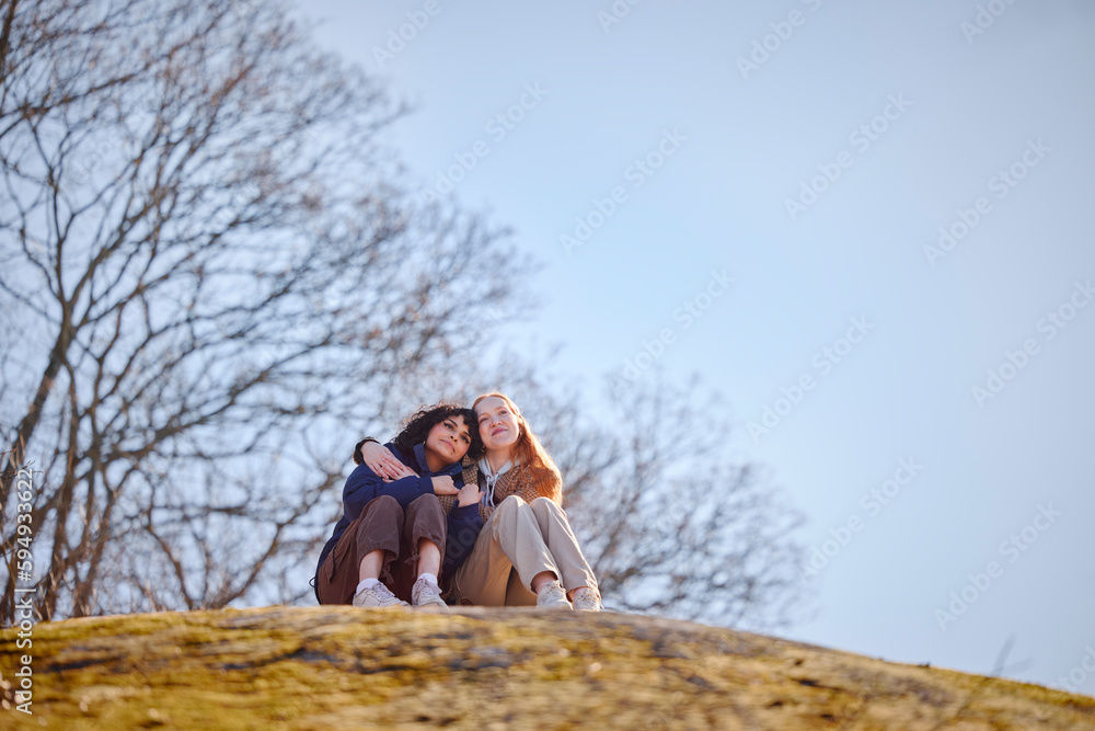 Young women hugging in park Young women hugging in park
