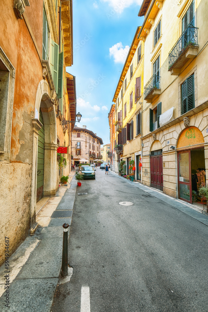 Obraz premium Fantastic narrow street of shops and cafes in the historic medieval old town center of Verona.