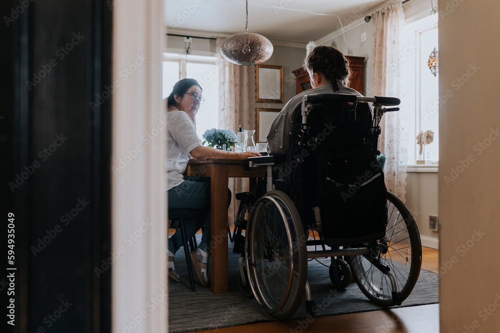 Mother with daughter sitting at table Mother with daughter sitting at table