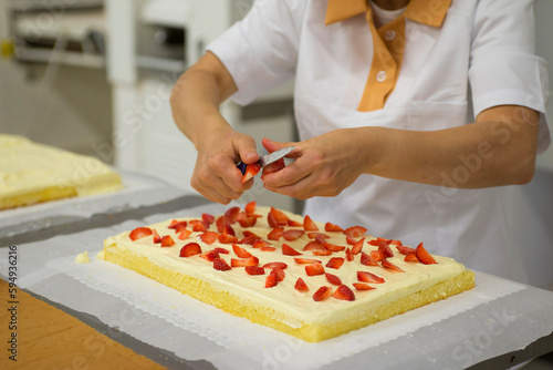 artisanal preparation of pastry desserts - cake with strawberries  