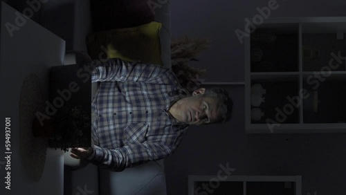 Vertical Video of Man working from home is having a power outage.